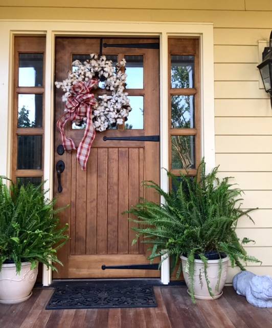 Elegant wooden entrance door with wreath